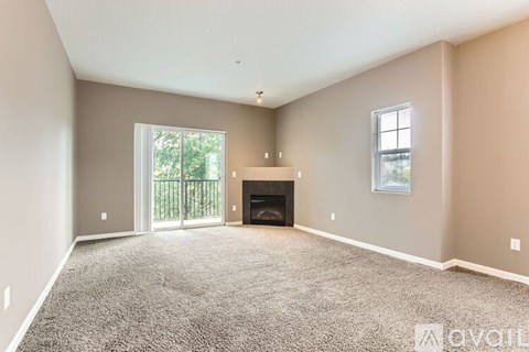 A spacious living room with a fireplace and sliding glass doors.