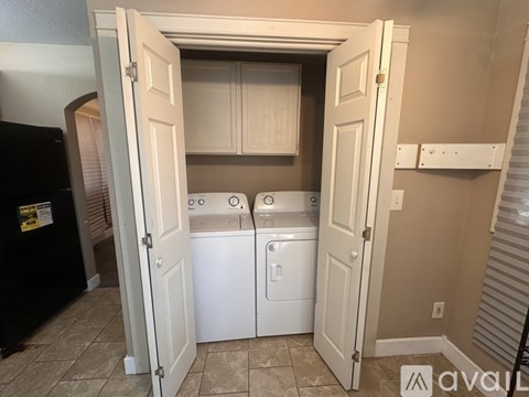 A laundry room with a washer and dryer.