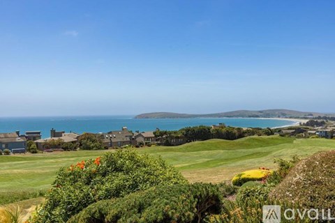 A golf course with a view of the ocean.