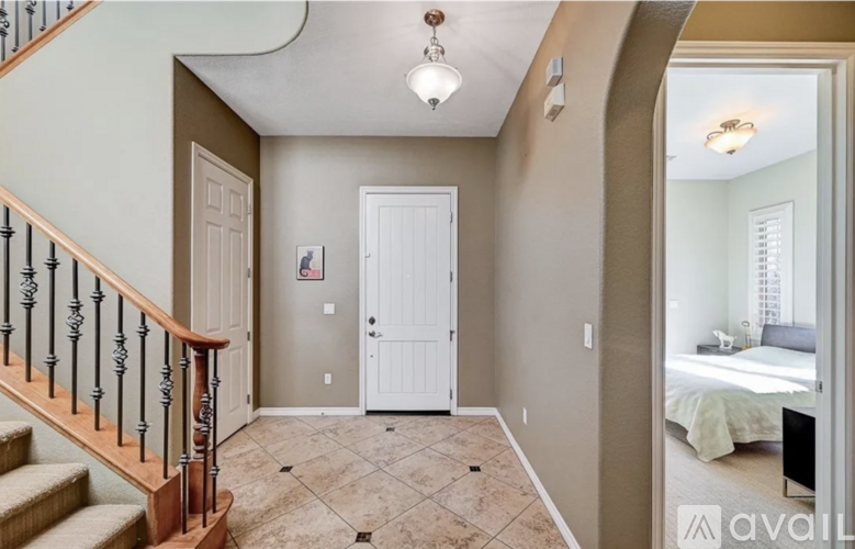 A bedroom with a bed and a dresser is visible through the open door.