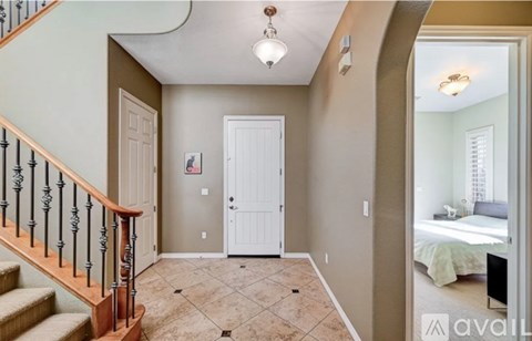 A bedroom with a bed and a dresser is visible through the open door.