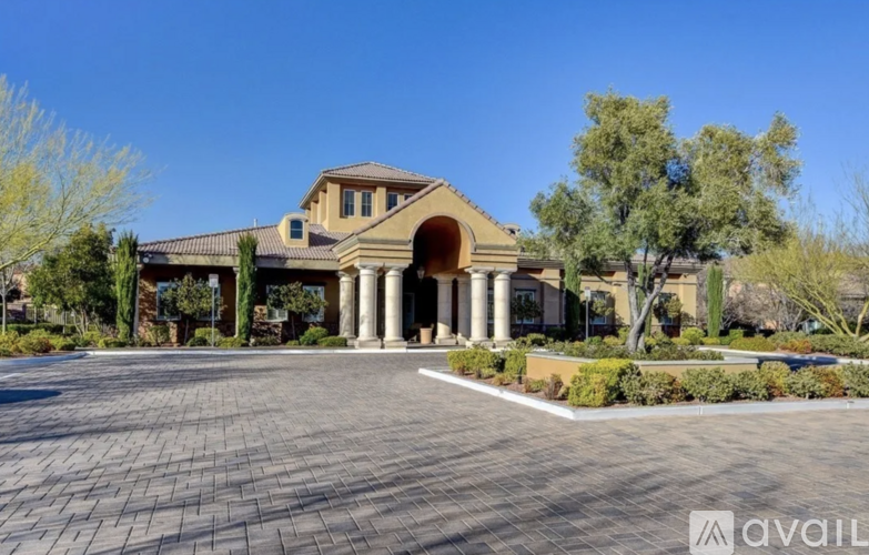 A large house with a driveway in front.