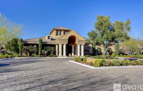 A large house with a driveway in front.
