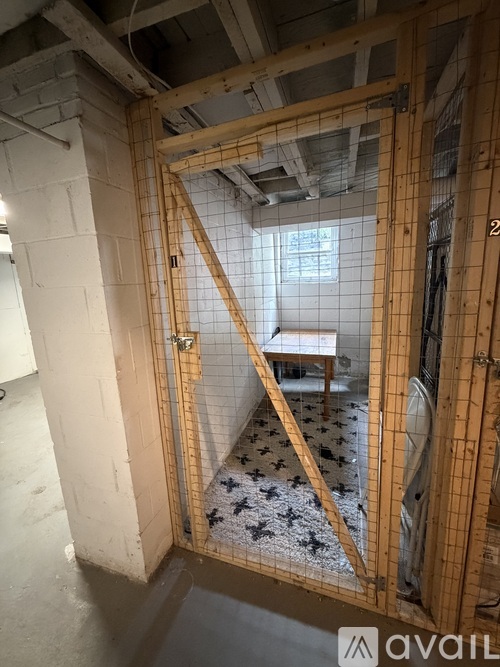 A room under construction with wooden framing and a white tiled floor.