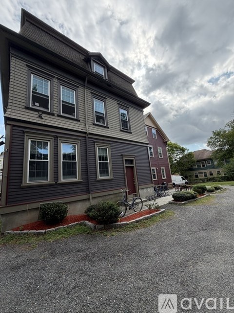 A house with a red door and a bicycle parked in front.