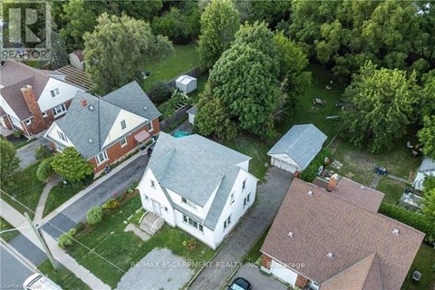 A bird's eye view of a residential area with houses and trees.