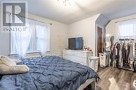 A bedroom with a bed, a wardrobe, and a window.