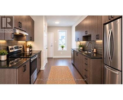 A modern kitchen with stainless steel appliances and wooden cabinets.