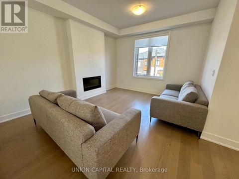 A living room with a fireplace and two couches.