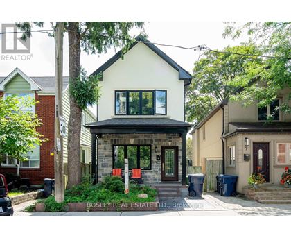 A house with a front yard and a sign that says Bosley Real Estate LTD.