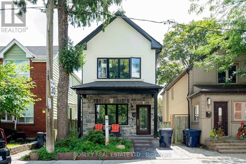 A house with a front yard and a sign that says Bosley Real Estate LTD.