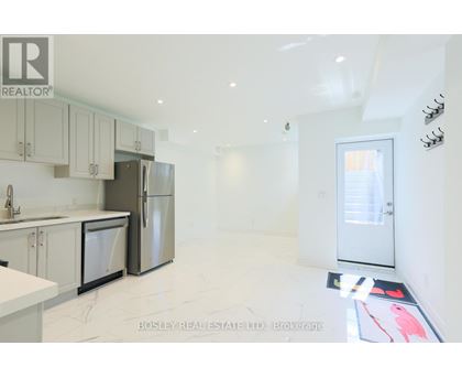 A kitchen with white cabinets and appliances is on the market with Bosley Real Estate.