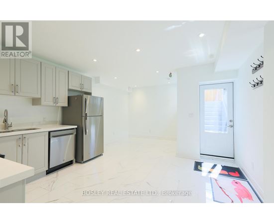 A kitchen with white cabinets and appliances is on the market with Bosley Real Estate.