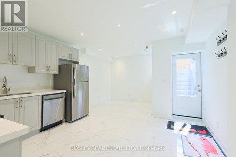 A kitchen with white cabinets and appliances is on the market with Bosley Real Estate.