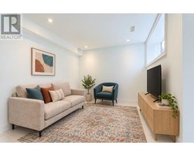 A living room with a couch, chair, and television.