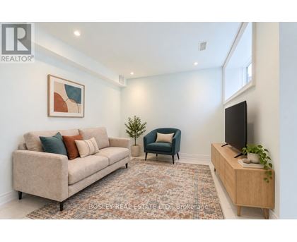 A living room with a couch, chair, and television.