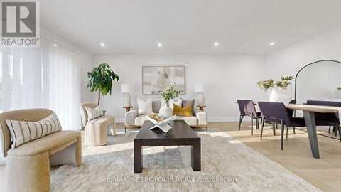 A modern living room with a coffee table, couches, and a potted plant.