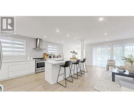 A modern kitchen with white cabinets and a central island.