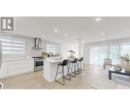 A modern kitchen with white cabinets and a central island.