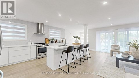 A modern kitchen with white cabinets and a central island.