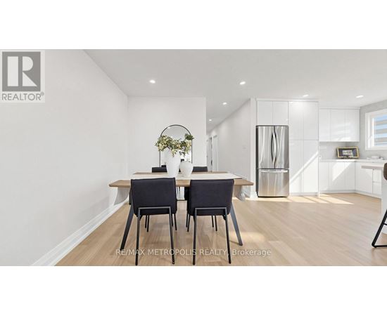 A dining room with a table and chairs.