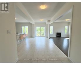 A spacious living room with a fireplace and sliding glass doors.