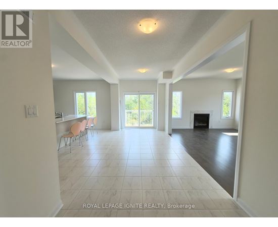 A spacious living room with a fireplace and sliding glass doors.