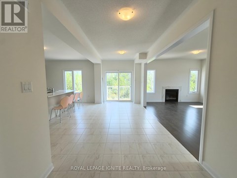 A spacious living room with a fireplace and sliding glass doors.