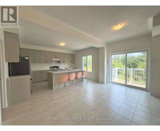 A spacious kitchen and dining area with a television and sliding glass doors.