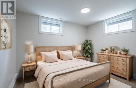A bedroom with a large bed, nightstands, and a dresser.