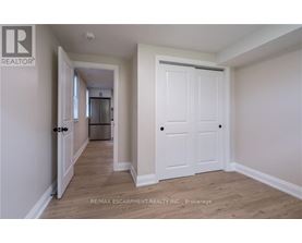 A white door is in the middle of a hallway.