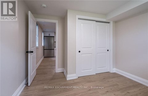A white door is in the middle of a hallway.