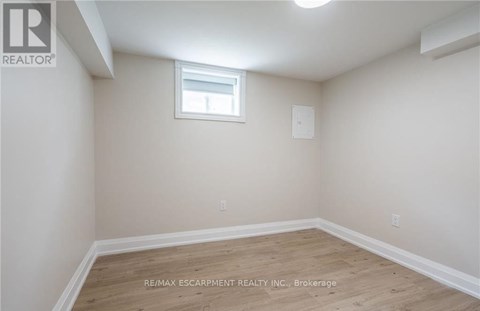 A room with a window and wooden flooring.