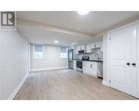 A well-lit, spacious kitchen with white cabinets and a microwave above the stove.