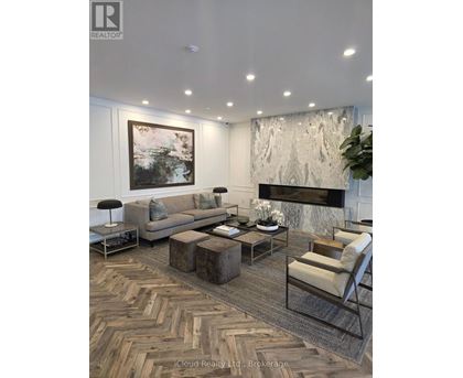 A living room with a grey sofa, a coffee table, and a fireplace.