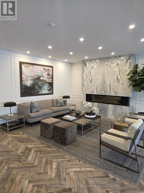 A living room with a grey sofa, a coffee table, and a fireplace.