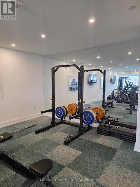 A gym with a weight rack and weights.