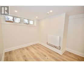 A room with a white wall and a white radiator on the wall.