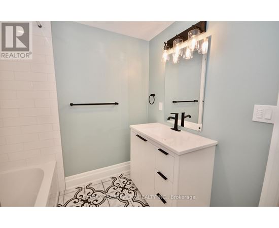 A white bathroom sink with a mirror above it.