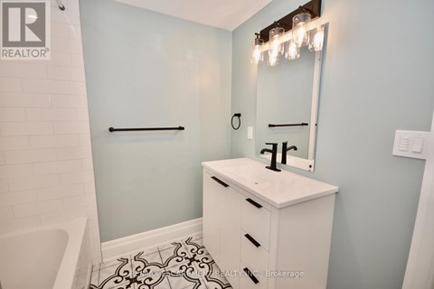 A white bathroom sink with a mirror above it.