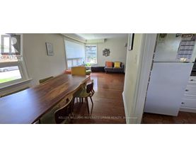 A kitchen with a table and chairs in the middle of the room.