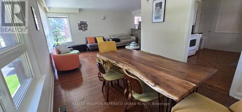 A dining room with a wooden table and chairs.