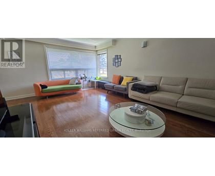 A living room with a green couch and a white coffee table.