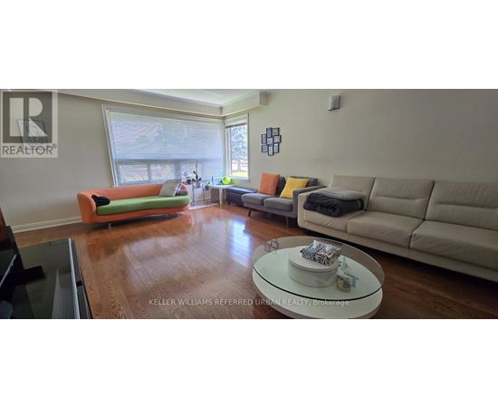 A living room with a green couch and a white coffee table.