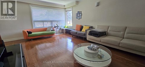 A living room with a green couch and a white coffee table.