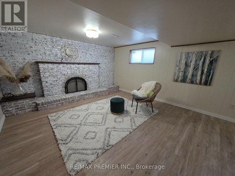 A living room with a fireplace and a chair.