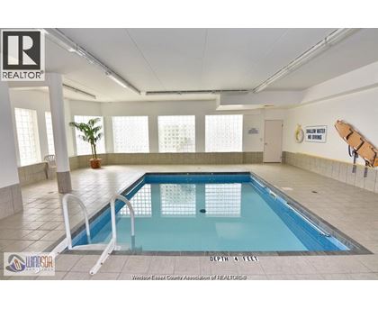 A large indoor swimming pool with a depth of 4 feet.