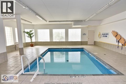 A large indoor swimming pool with a depth of 4 feet.