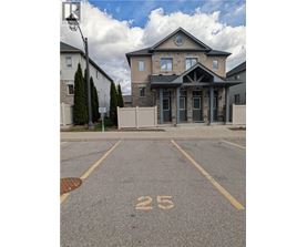 A house with the number 25 painted on the parking lot.