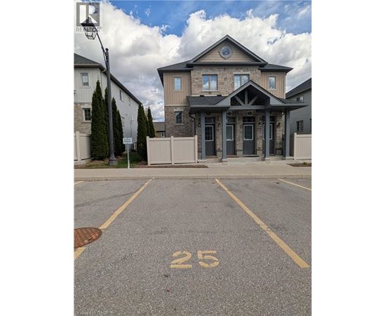 A house with the number 25 painted on the parking lot.